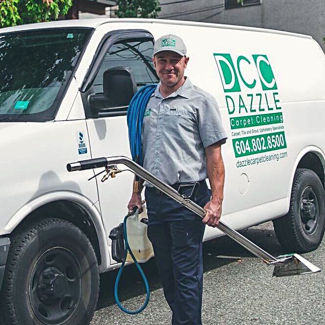 Dazzle technician standing beside the Dazzle van with the cleaning wand